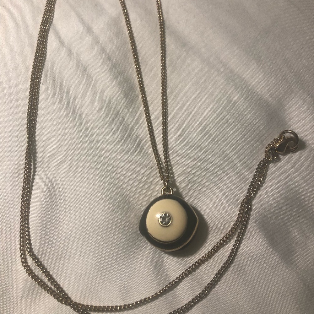 Long gold color necklace with black pendant
